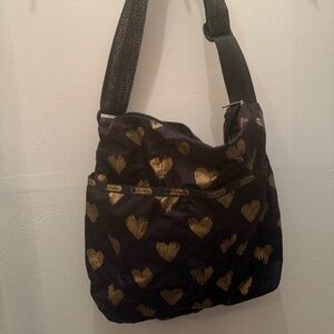 LeSportsac black crossbody bag with gold heart details